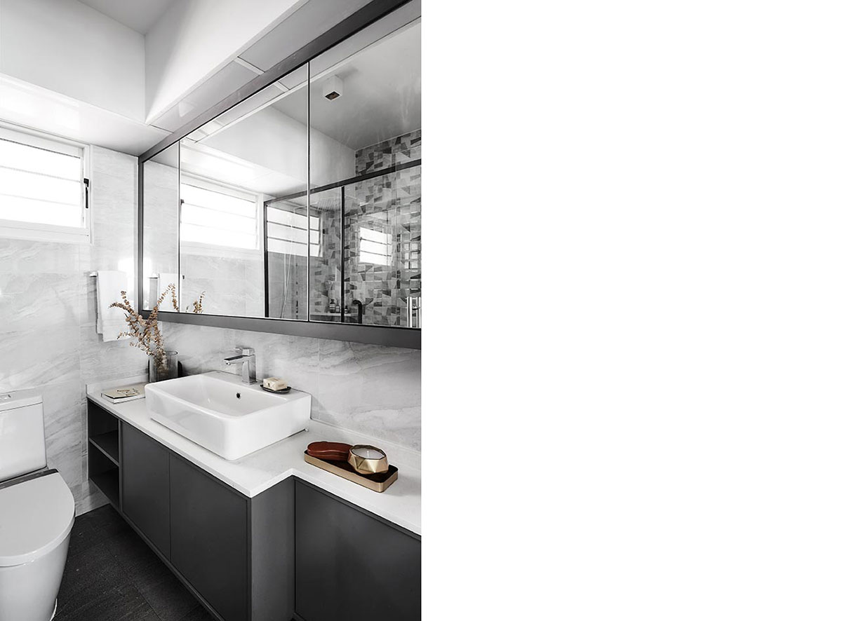 Equipped with natural stone-lookalike tiles and premium fittings like an American Standard sink and WC, the master bathroom was given a classy and elegant makeover akin to those found in high-end hotels.
