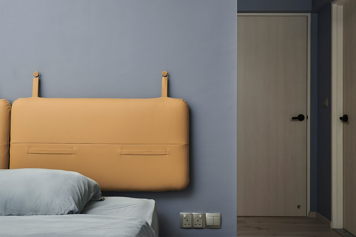 Instead of a regular bedhead, the designers hung the custom-designed padded headboards on the blue-coloured wall for a lightweight appeal.