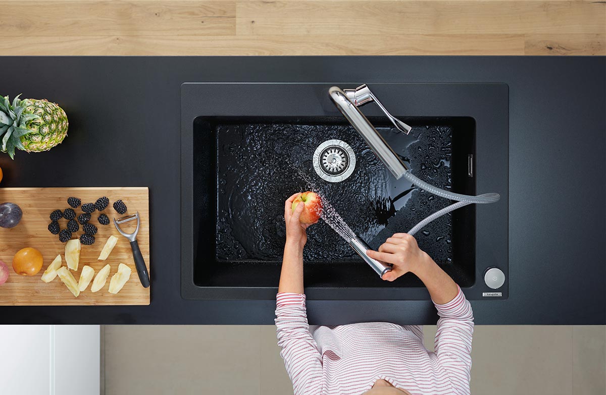 SquareRooms-hansgrohe-silicatec-granite-kitchen-sink-woman-hand-washing-apple