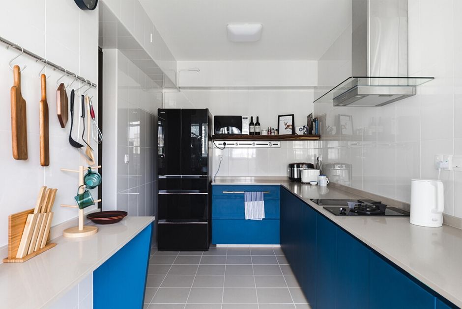 KITCHEN: With the occupants not requiring much storage units here, the utilitarian zone was only fitted with base cabinets, which contributes to a spacious and airy atmosphere in the space. 