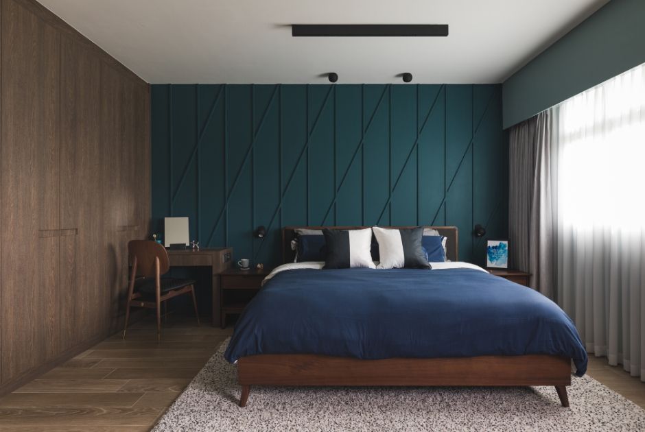 MASTER BEDROOM: Pairing well with the wood-effect tiles on the floor, the row of built-in cabinetry covered in dark wood laminates complete the sophisticated, yet cosy look of the bedroom. 