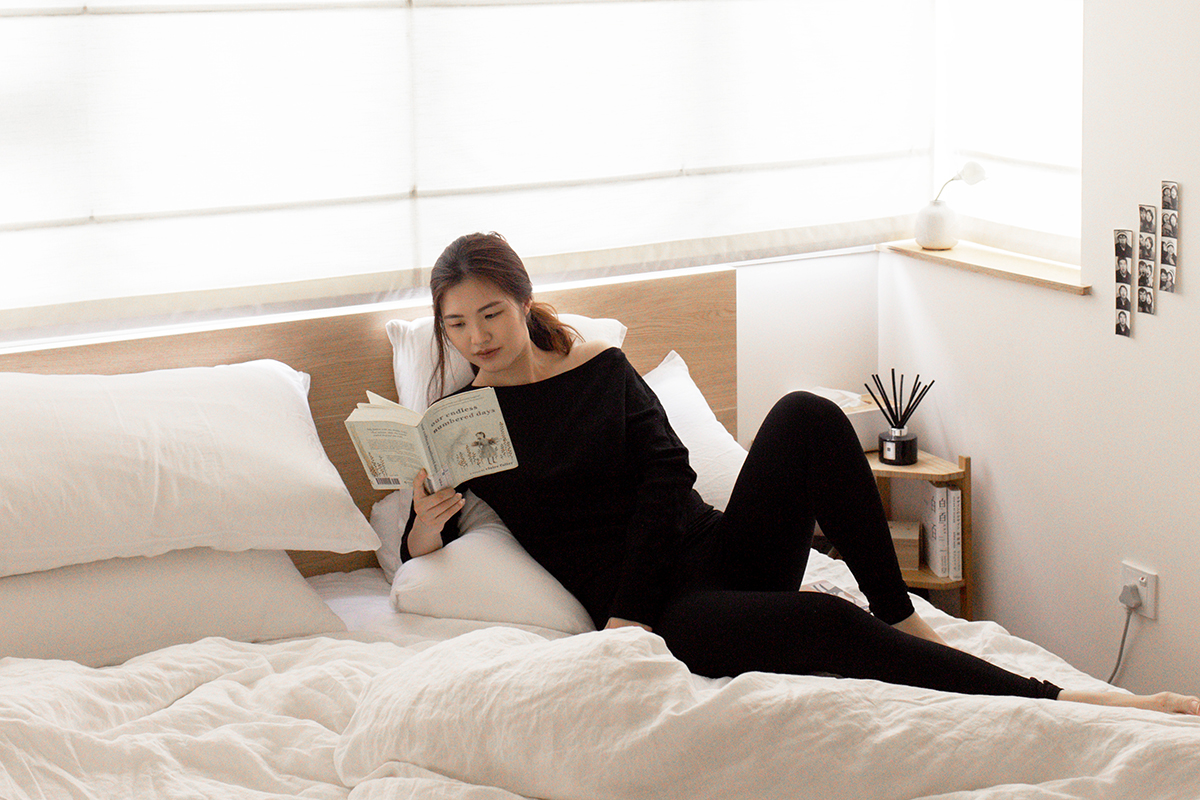 squarerooms monica anne lie minimalist bedroom woman reading book white bed scandinavian design