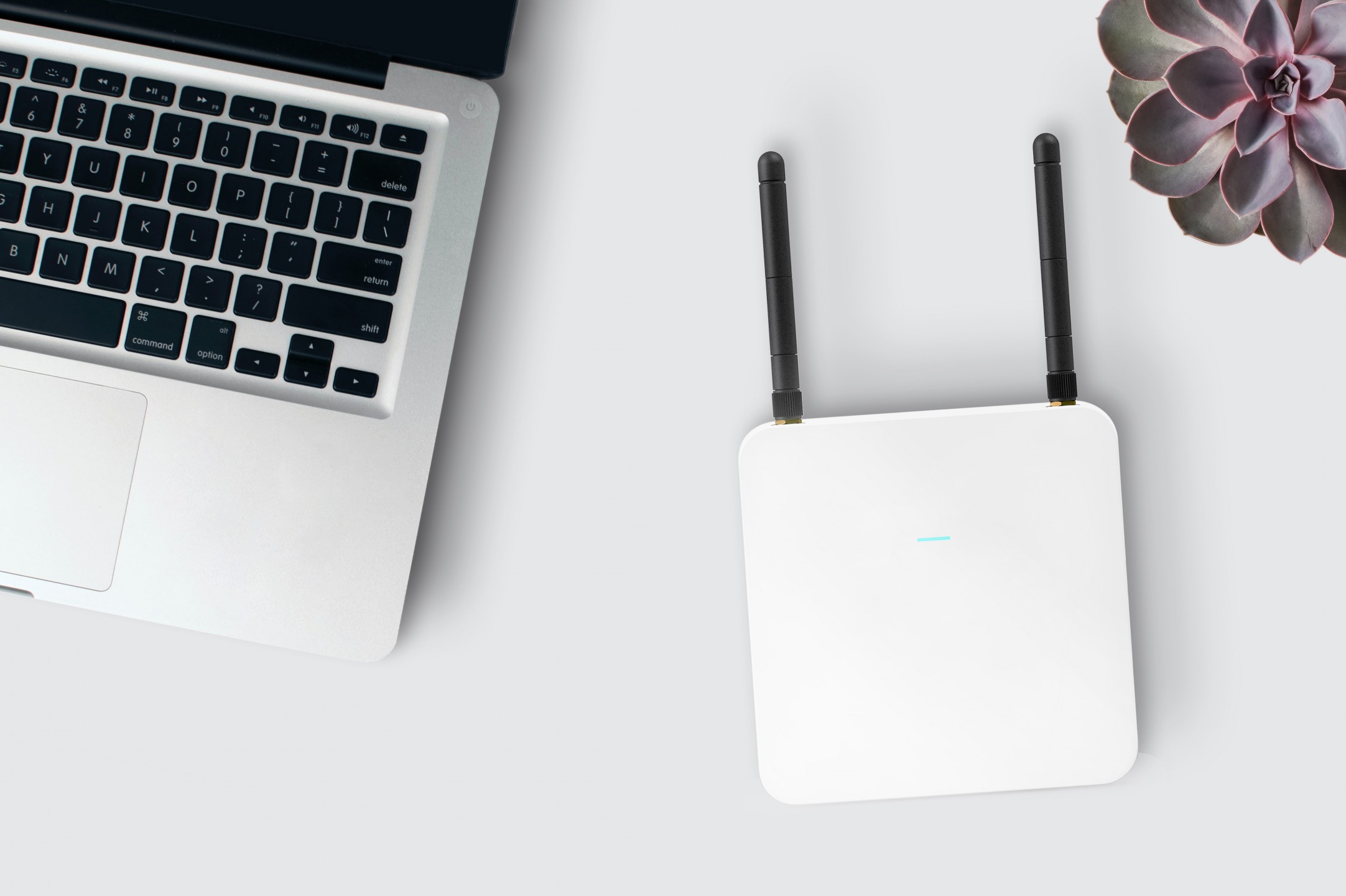 squarerooms inlytics laptop with wifi router white tabletop flatlay
