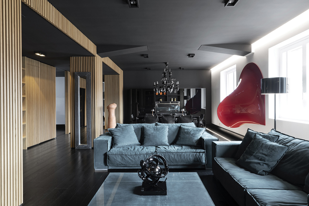 squarerooms damilano studio milan apartment monochromatic sleek minimalist modern living room blue couch red artwork