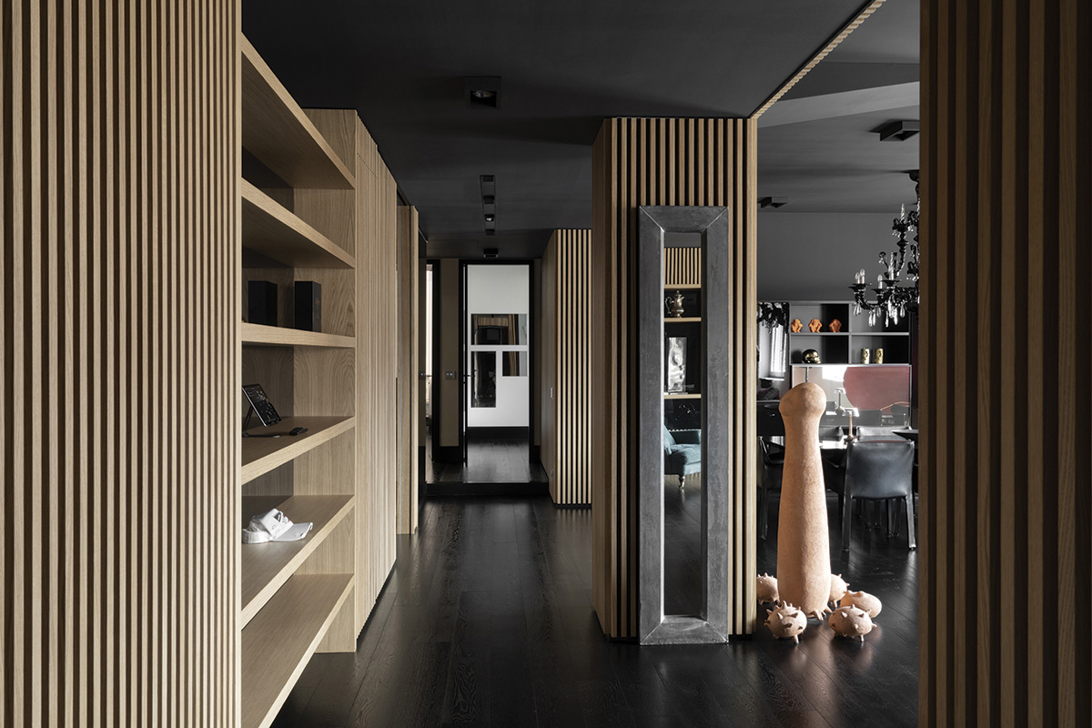 squarerooms damilano studio milan apartment monochromatic sleek minimalist modern overall view living area common wood shelves art