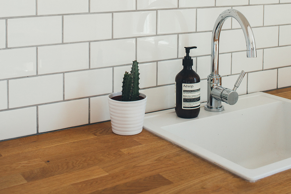 charles-deluvio squarerooms wooden countertop kitchen sink white tap faucet tiles backsplash