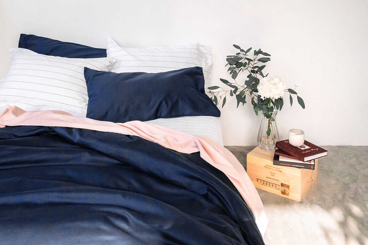 squarerooms sojao organic cotton bedsheets dark blue navy pink stripes white wall bedroom