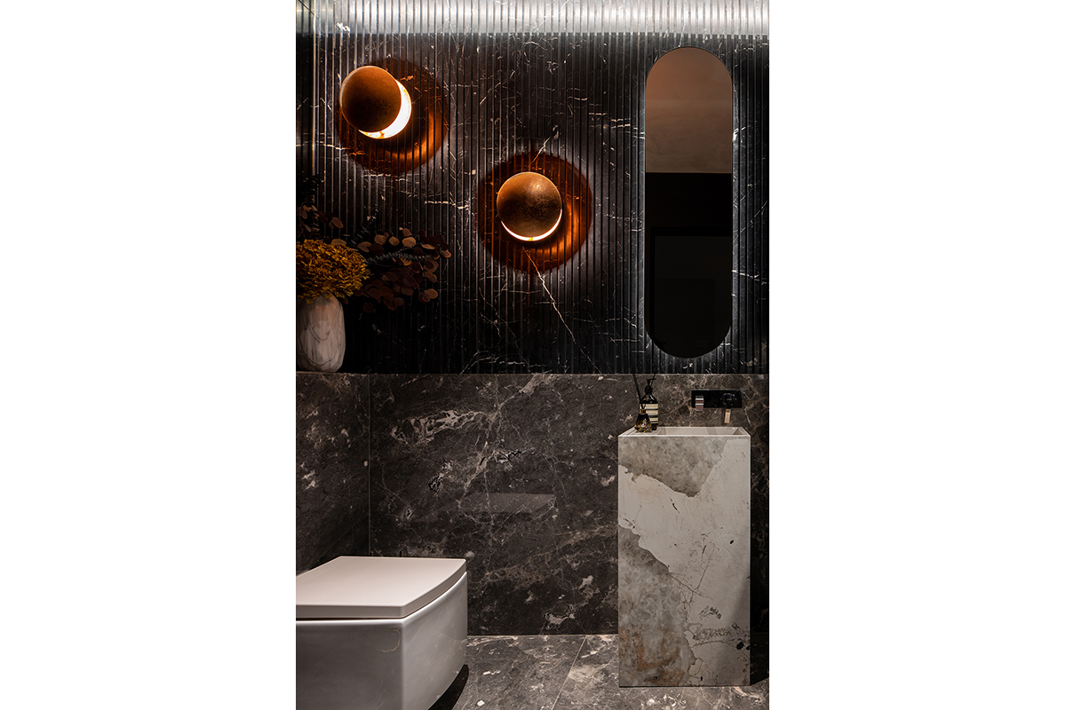squarerooms abcd a blue cube design showroom modern luxury luxe dark marble commercial space bathroom washroom toilet sink dekton cosentino eclipse lights rose gold fluted black grey walls
