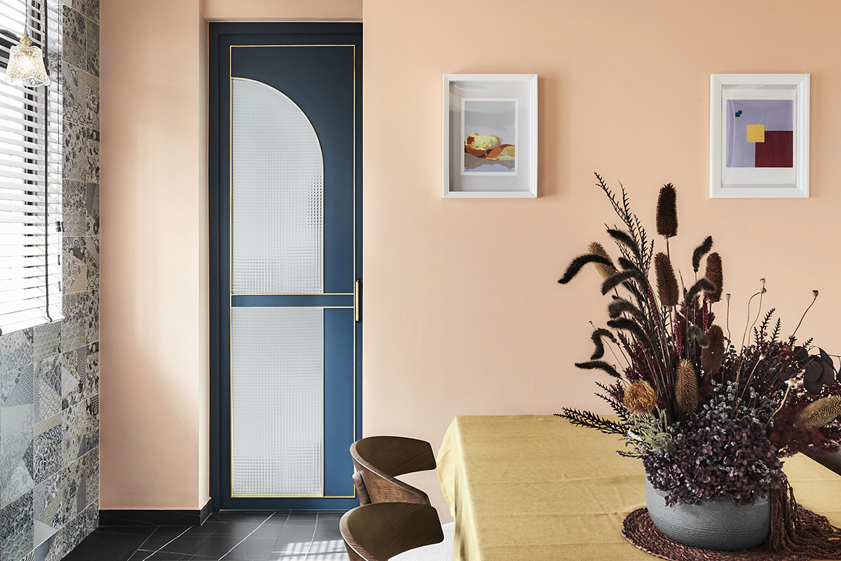 squarerooms linear space concepts eclectic colourful home interior design singapore east coast walk up apartment style maximalist bold vintage look dining room area orange salmon peach colour wall yellow table blue arched door artwork