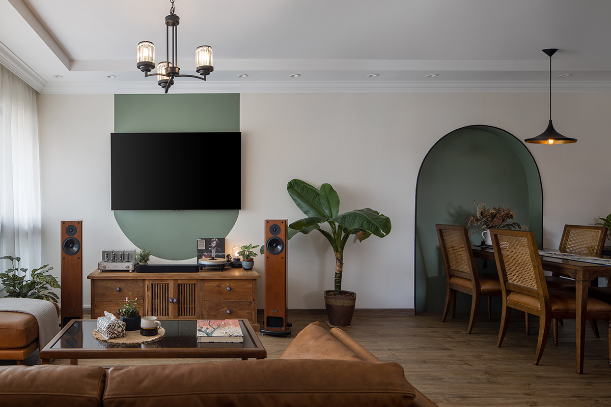 squarerooms fifth avenue interior home renovation interior design boho tropical look jungalow aesthetic 4 room hdb flat in bishan living dining room green wall paint feature curved oval rounded arch rustic vietnamese wood furniture