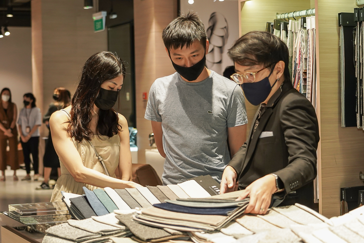 squarerooms king living kallang showroom event july 2022 homeowners invited furniture discovery couple looking at fabric samples with store retail staff