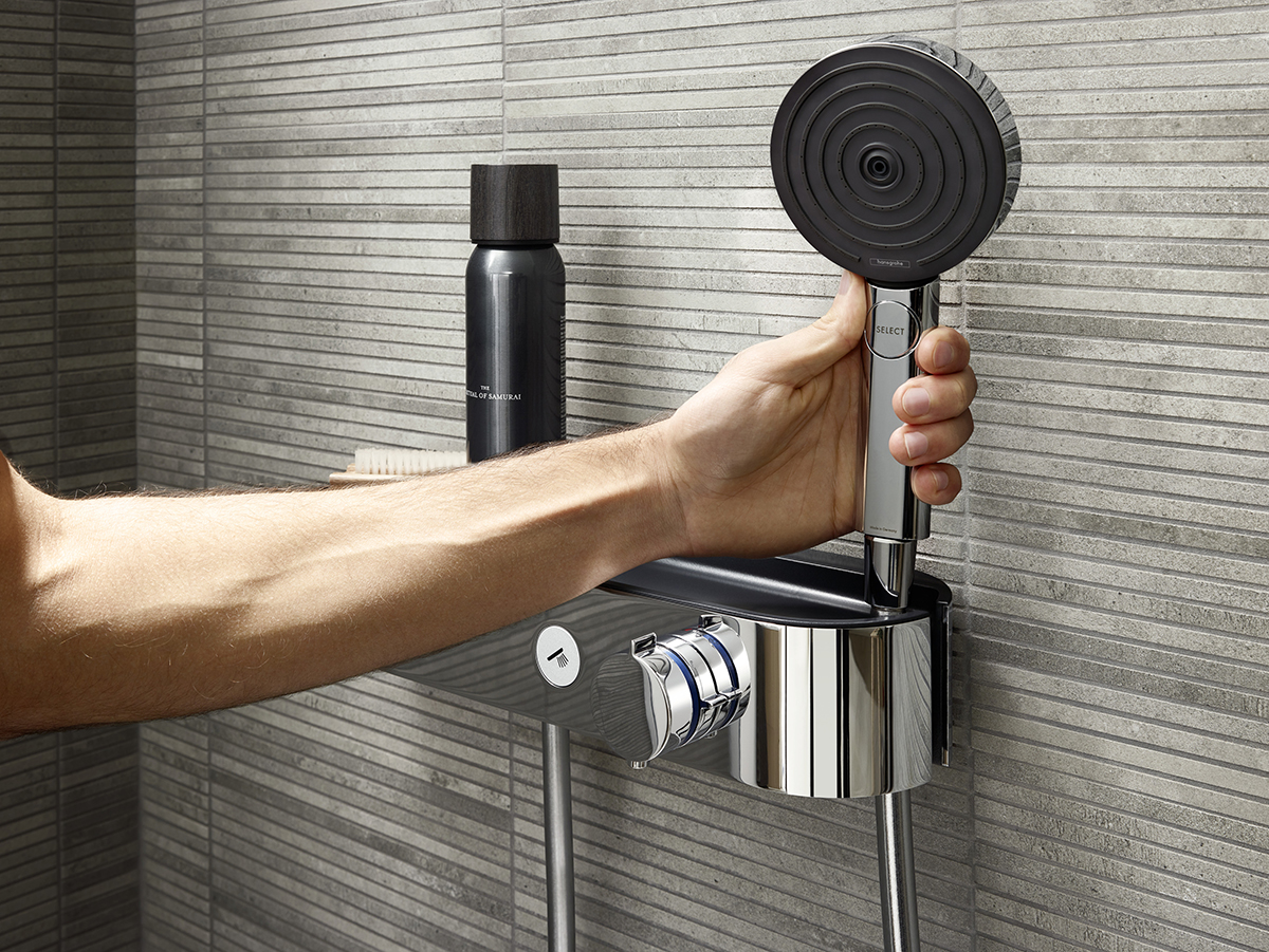 squarerooms hansgrohe pulsify shower head handshower black chrome modern minimalist bathroom fittings space saving apartment fixtures accessories arm hand reaching grabbing holding shower