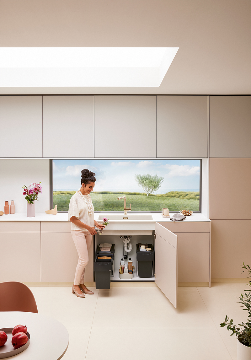 blanco subline kitchen organisation system blanco unit fittings cream minimalist modern cabinets woman throwing away trash